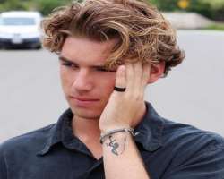 He has a small tattoo on his left wrist.